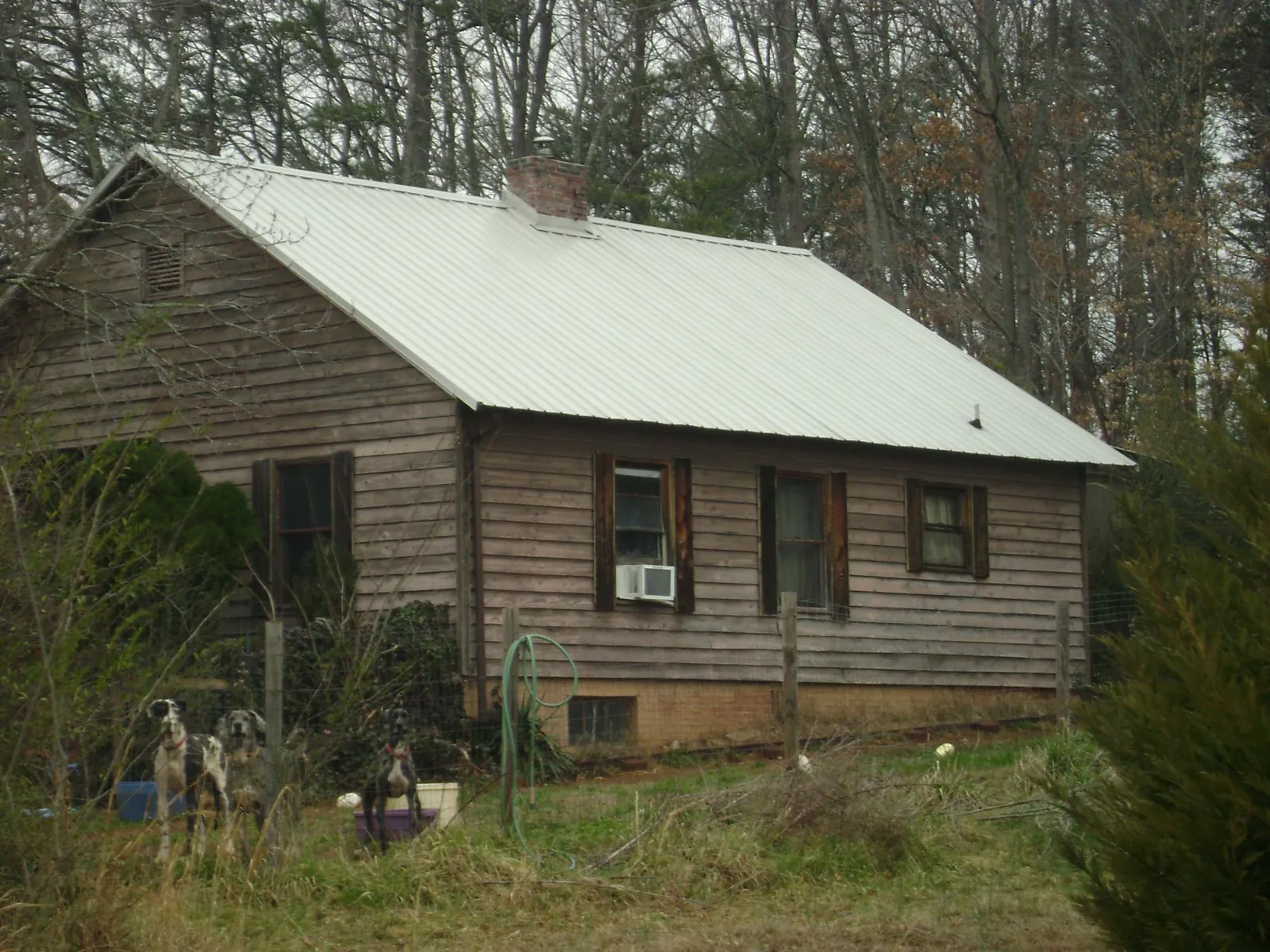 White metal roof on an old wood sided farmhouse, from a Metal Roof Installation job in Bealeton